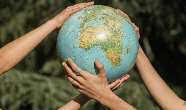 Hands holding a globe of Earth.