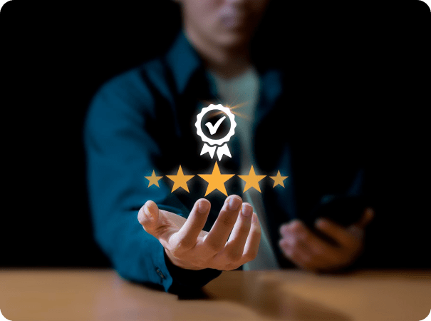 A person in a dark, blurred background holds out their hand, appearing to interact with five gold stars and a verified badge floating above their palm, symbolizing high-quality service or excellent performance.